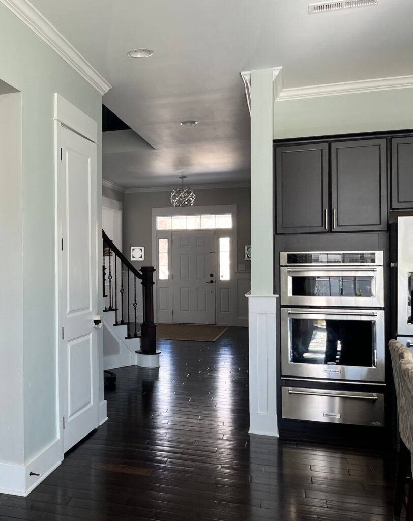 Sherwin Williams Sea Salt, green blue paint color, dark wood floors and cabinets, stainless steel, white trim