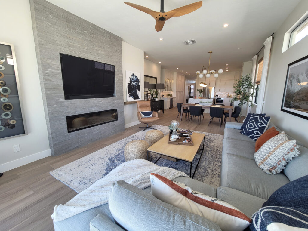Trendy open concept home, home staging ideas, Dunn Edwards Foggy Day, similar toDrift of Mist, sectional, Blue & orange accents. ceiling fan