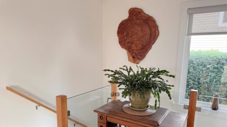 Staircase with fir wood railing, natural light, indigenous carving painted in BEnjamin Moore Cloud White
