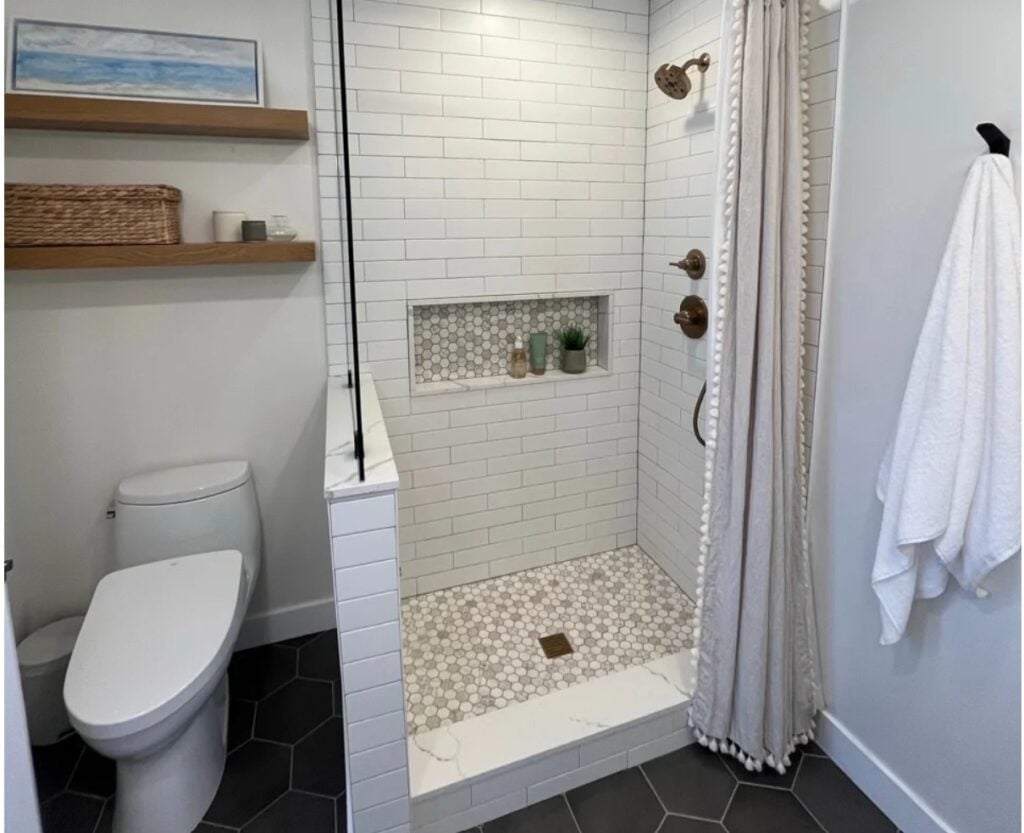 Sherwin Williams Alabaster in a bathroom with small walk in shower with curtain, subway tile on shower walls
