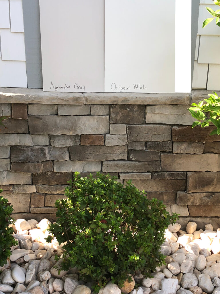 AGREEABLE GRAY, ORIGAMI WHITE, on exterior siding with stone accents. Best off white paint colors. Kylie M Interiors Edesign
