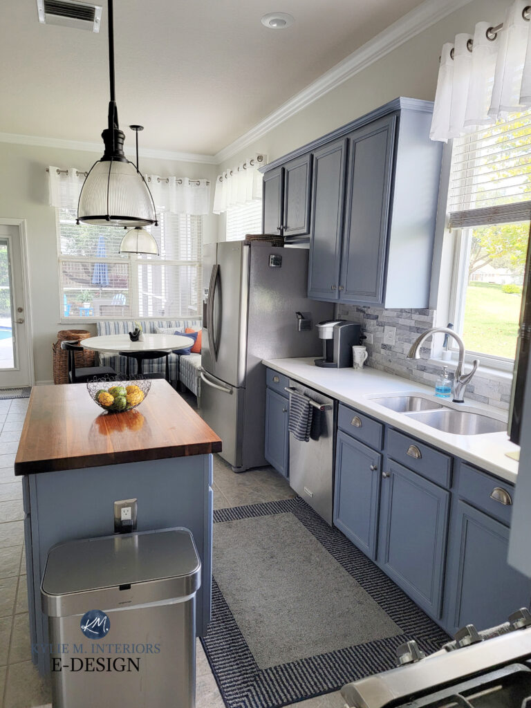 Benjamin Moore Bachelor Blue, best blue-violet with off-white walls, marble backsplash. Island and kitchen cabinets painted. Kylie M Interiors