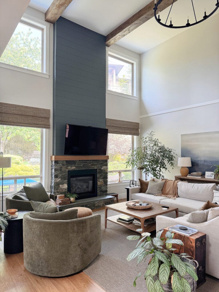 Sherwin Wiliams Aesthetic White in living room with high, vaulted ceiling and shiplap and K2 stone fireplace, sectional and pottery barn green accent chairs. North facing (2)