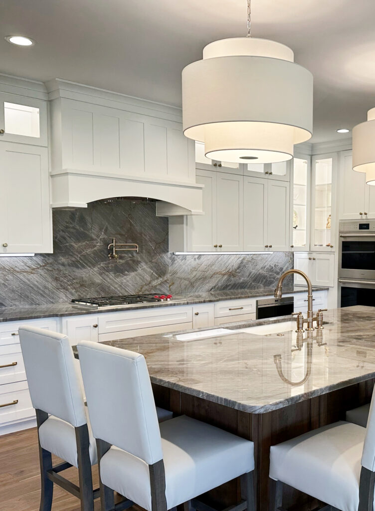 Kitchen island quartzite, gray quartz brown veins, pendant lights, Sherwin Williams Pure White cabinets, brass hardware, wood island, stools. Kylie M Online color consultant (3)