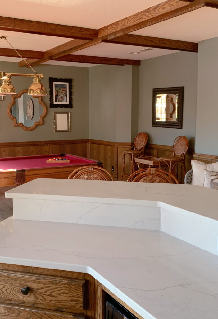 Sherwin Williams Evergreen Fog in pool table, family room, new white quartz countertop, oak cabinets, wood panelling, wainscoting with wood beams and trim.