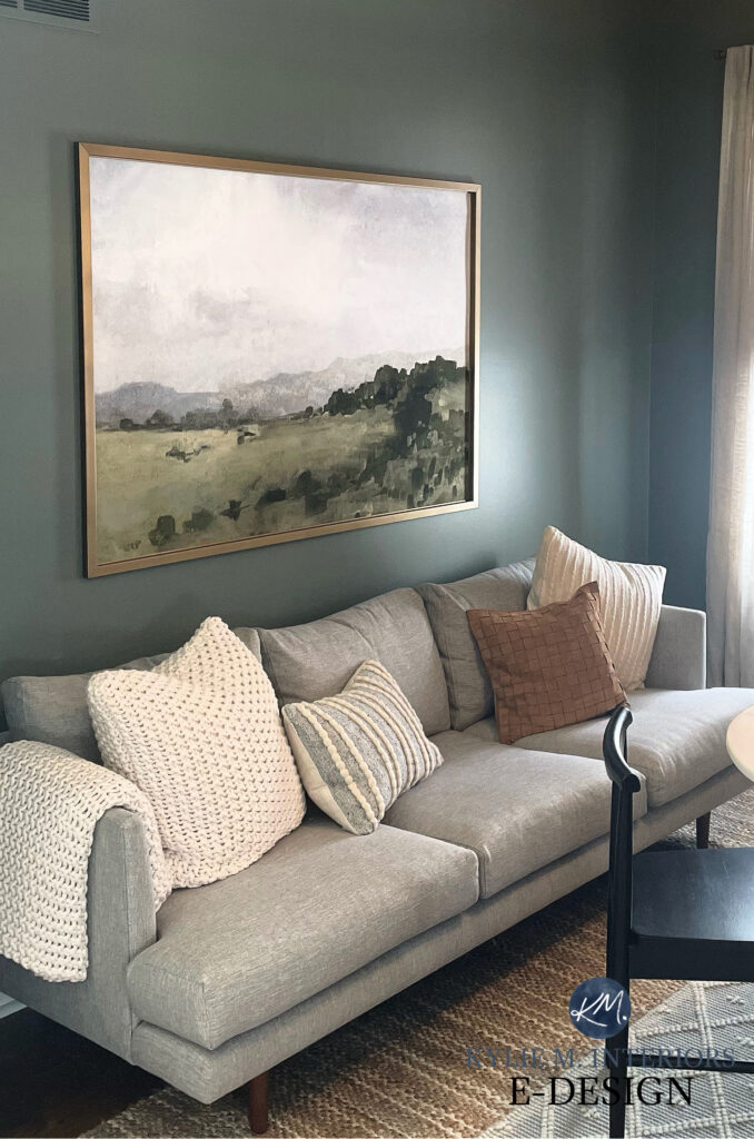Sherwin Williams Retreat in den with taupe sofa, landscape art, home decor. Best dark green paint color. Kylie M.