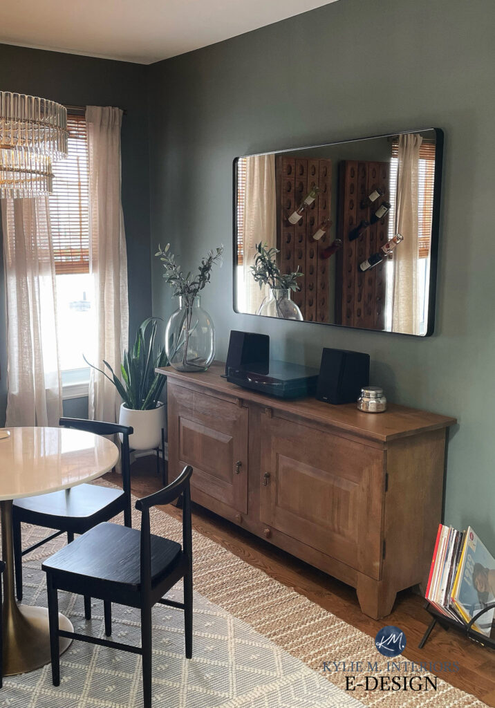 Small dining room with buffet, dark green paint color, Sherwin Williams Retreat, wood cabinet, marble table top. Kylie M, online paint color expert