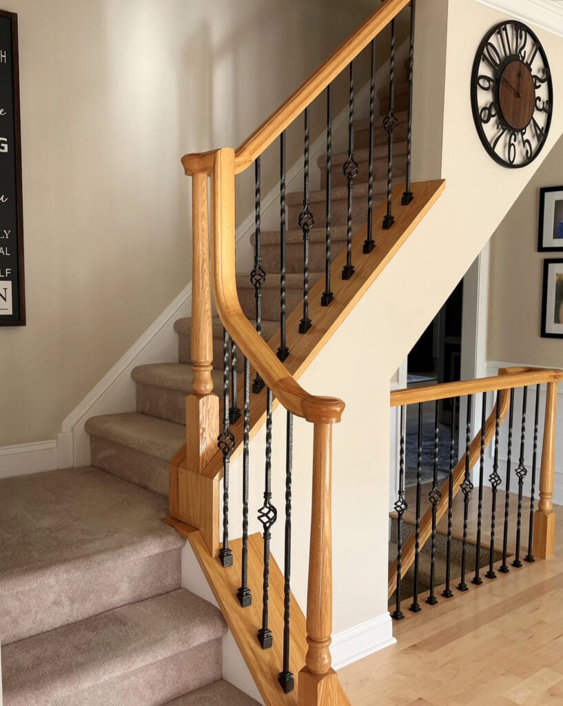 Staircase, pink toned beige carpet, oak hand railing, maple wood floor. update ideas for 2000s staircase
