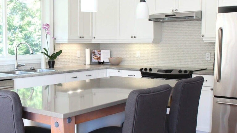 1990s kitchen updated with painted maple cabinets (benjamin moore cloud white), quartz island, laminate countertop