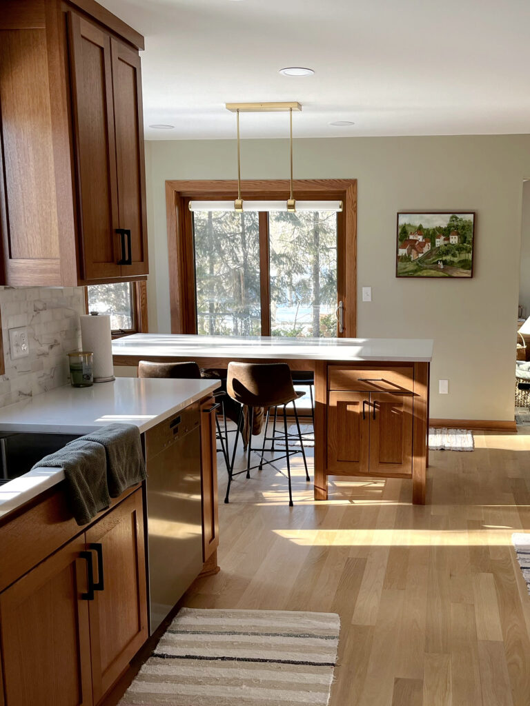 Red oak wood kitchen cabinet update, white quartz countertop, marble backsplash tile, island, wood trim, white oak floor.