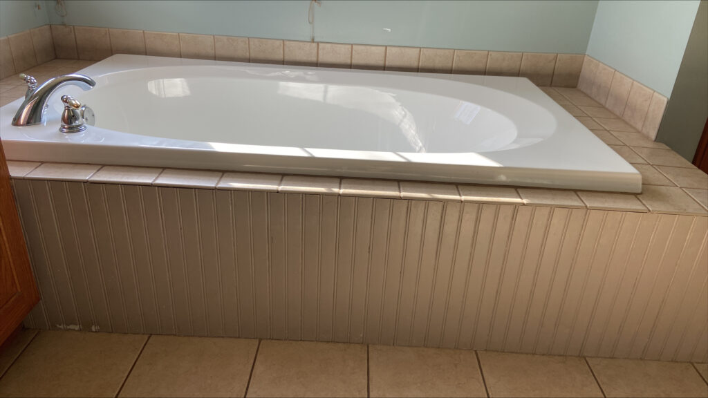 bathroom before update and remodel, tub with tile deck, oak wood vanity and wood trim (1)