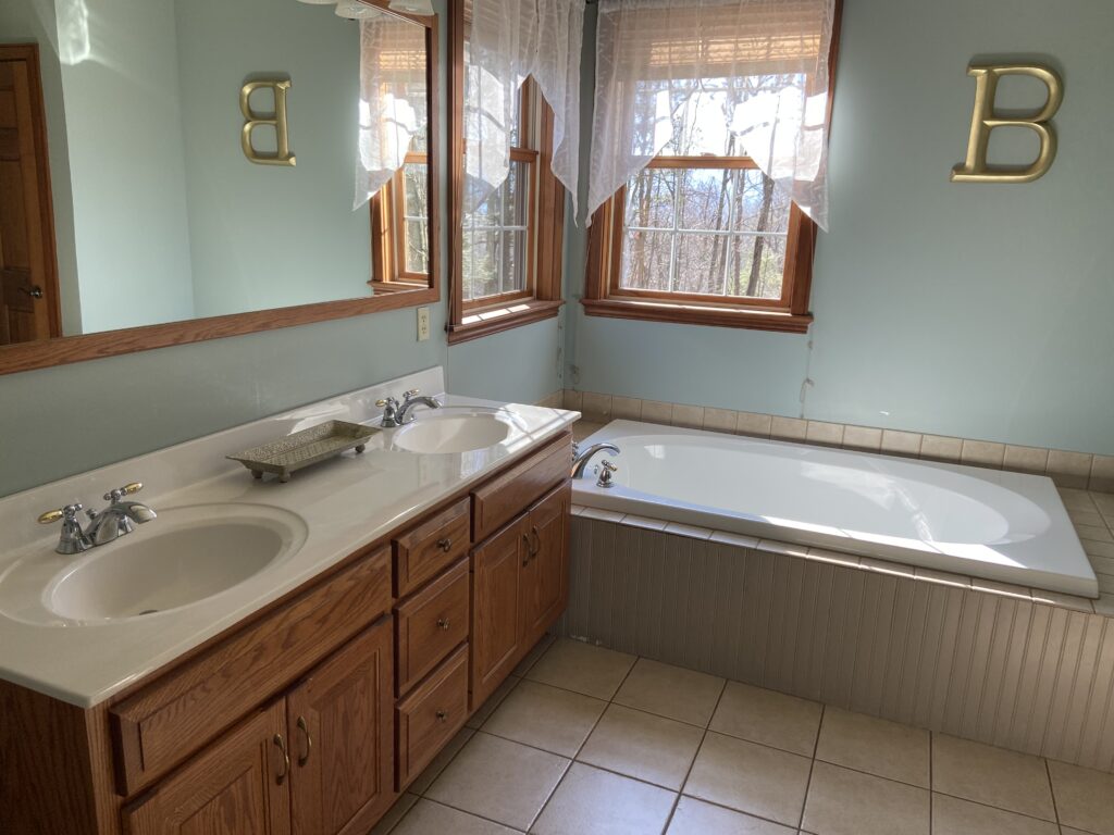 bathroom before update and remodel, tub with tile deck, oak wood vanity and wood trim (2)