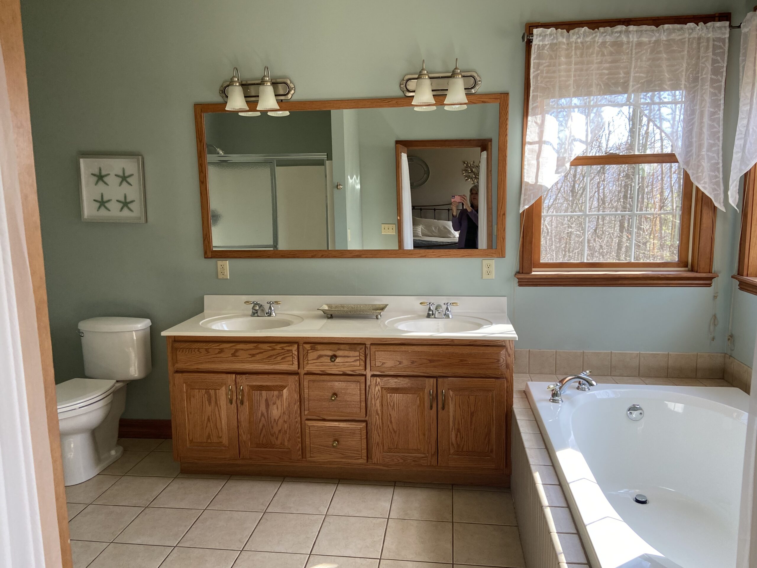 bathroom before update and remodel, tub with tile deck, oak wood vanity and wood trim (3)