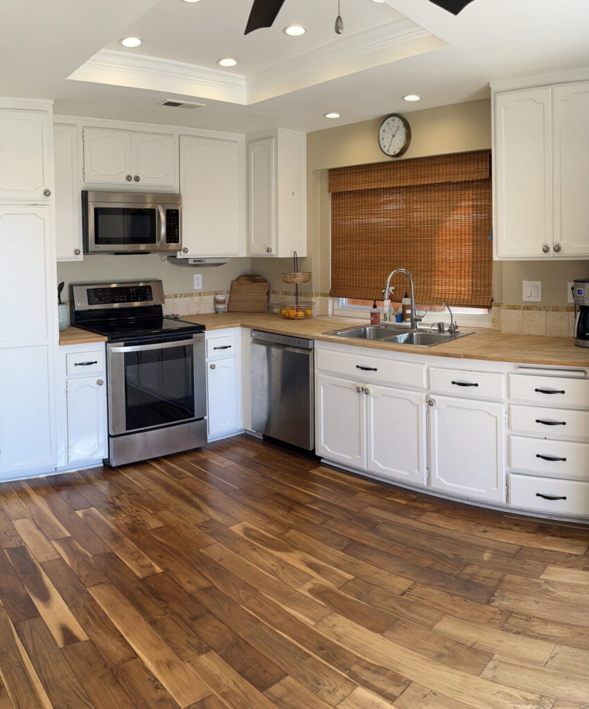 kitchen before update, tile and butcher block, wood floor
