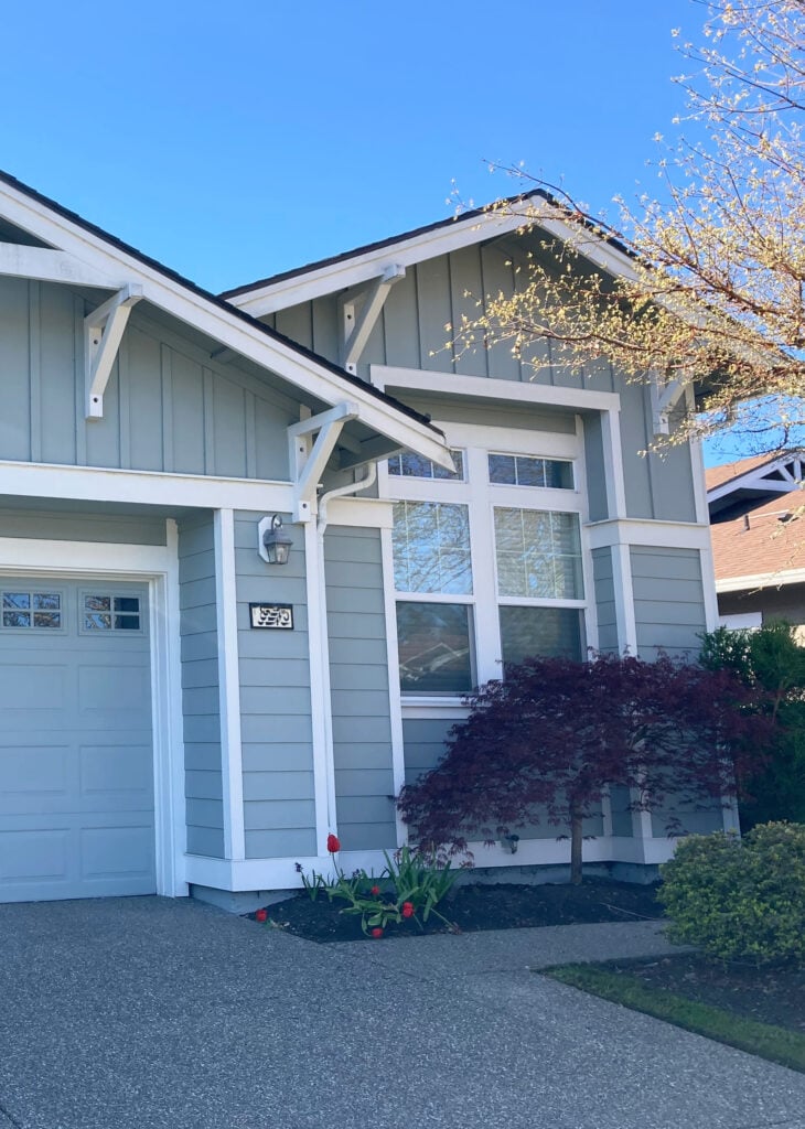 Exterior hardi siding and board and batten, Sherwin Williams Unusual Gray and Alabaster trim, white windows, north-facing