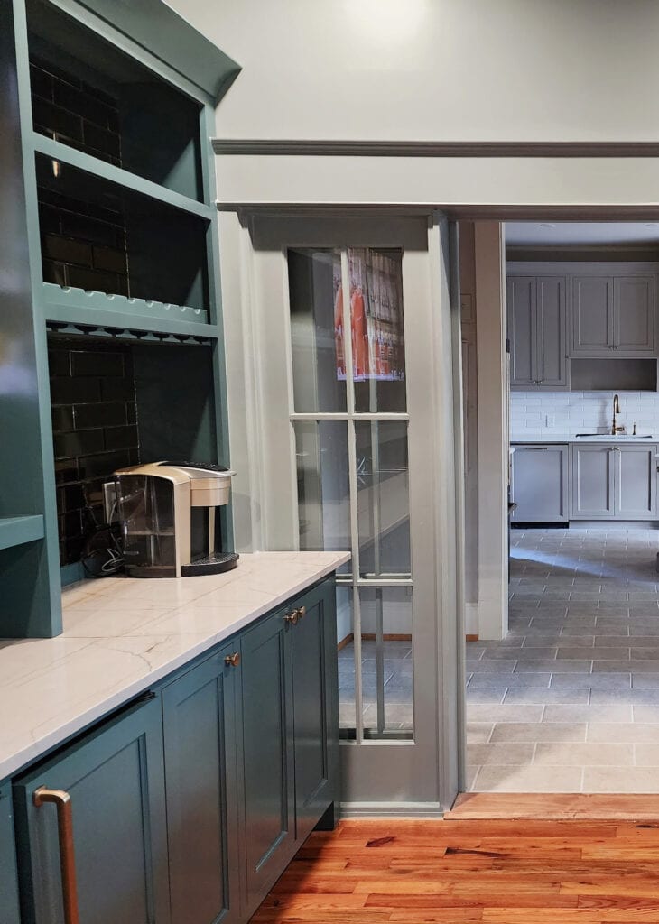 Sherwin Williams Still Water, blue-green teal painted cabinets, Stonybrook green gray paint color on walls and trims, wood floor, Ridgegate Cambria quartz countertop