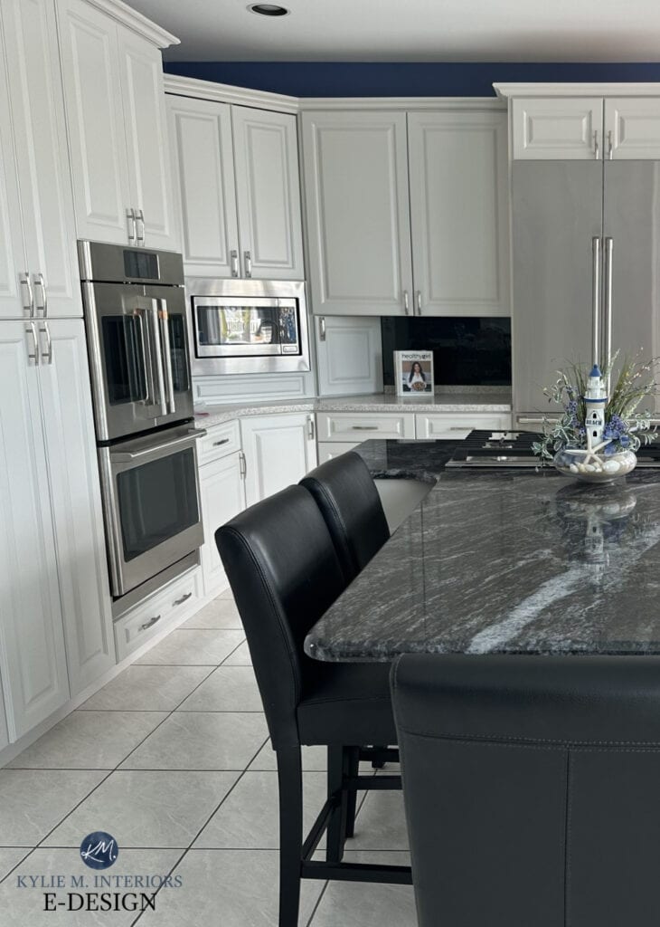BEnjamin Moore Nimbus painted warm gray cabinets, tile floor, granite island
