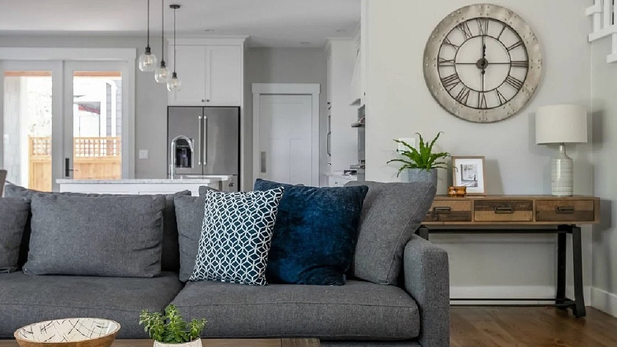 Benjamin Moore Stonington Gray walls, north-facing light with dark gray sectional