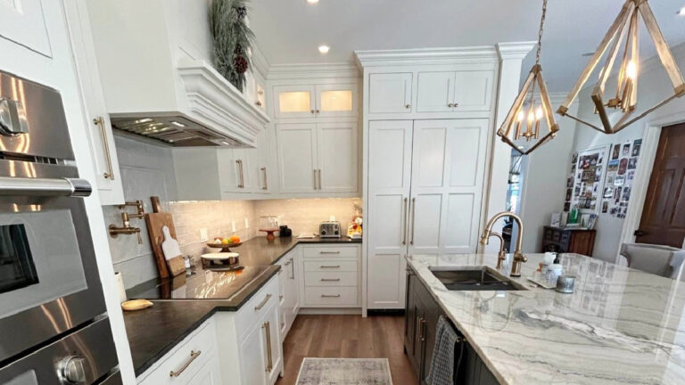 Sherwin Williams Pearly White on painted kitchen cabinets, black granite and quartzite counter on the island, wood flooring