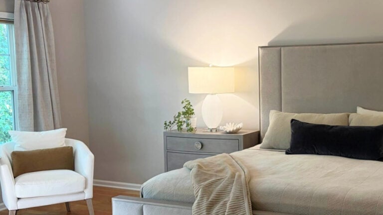 Sherwin Williams Popular Gray, a taupe paint color on bedroom walls in north-facing light with wood flooring