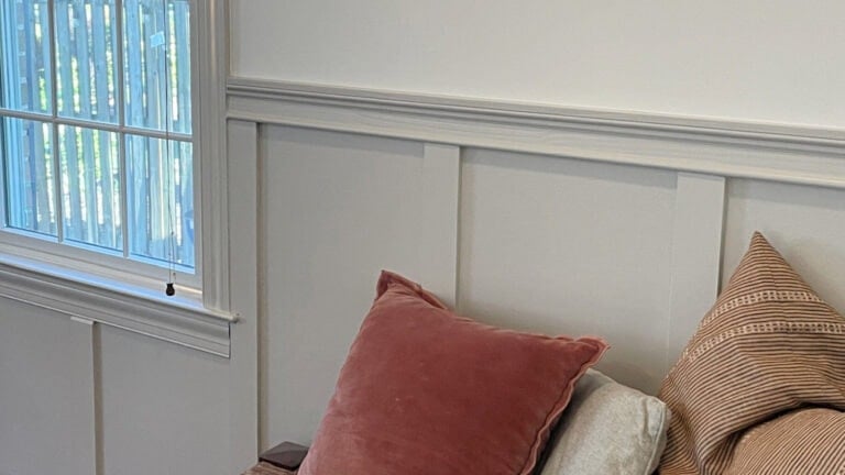 Benjamin Moore Chantilly Lace paint on walls with Sherwin Williams Agreeable Gray on board and batten lower walls