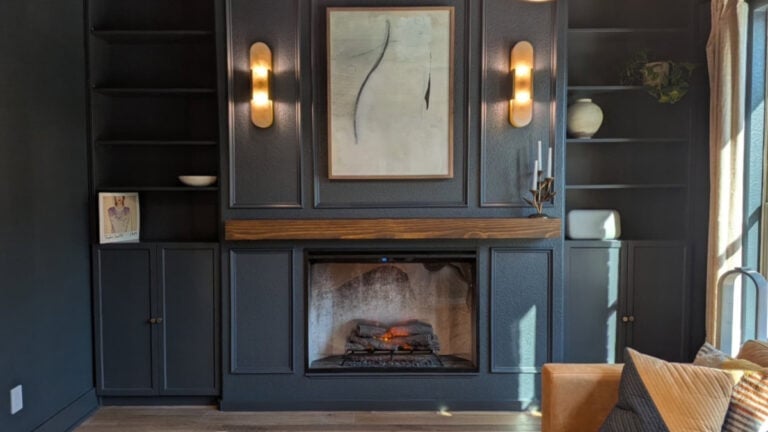Sherwin Williams Cyberspace, colordrenching in den or office with built-ins, wall sconces, fireplace and leather sofa