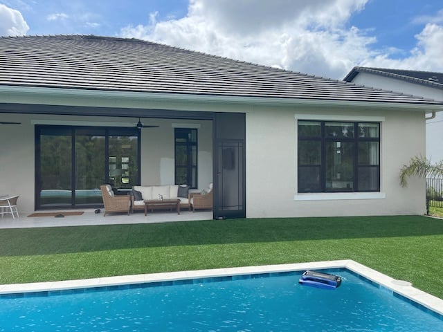 light tan paint color on exterior, florida home with pool, black windows, white trim