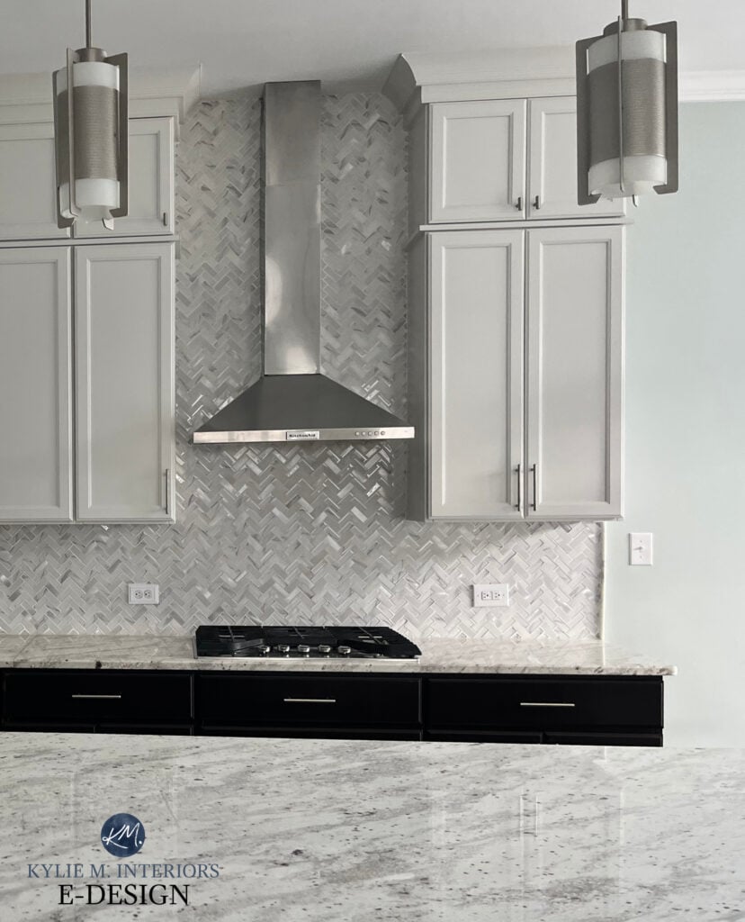 Sherwin Williams Drift of Mist painted kitchen cabinets, with granite countertop, herringbone mosaic tile and Sea Salt walls
