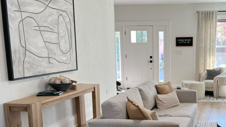 Sherwin Williams Greek Villa in living room with neutral home decor, sofa, and south-facing light