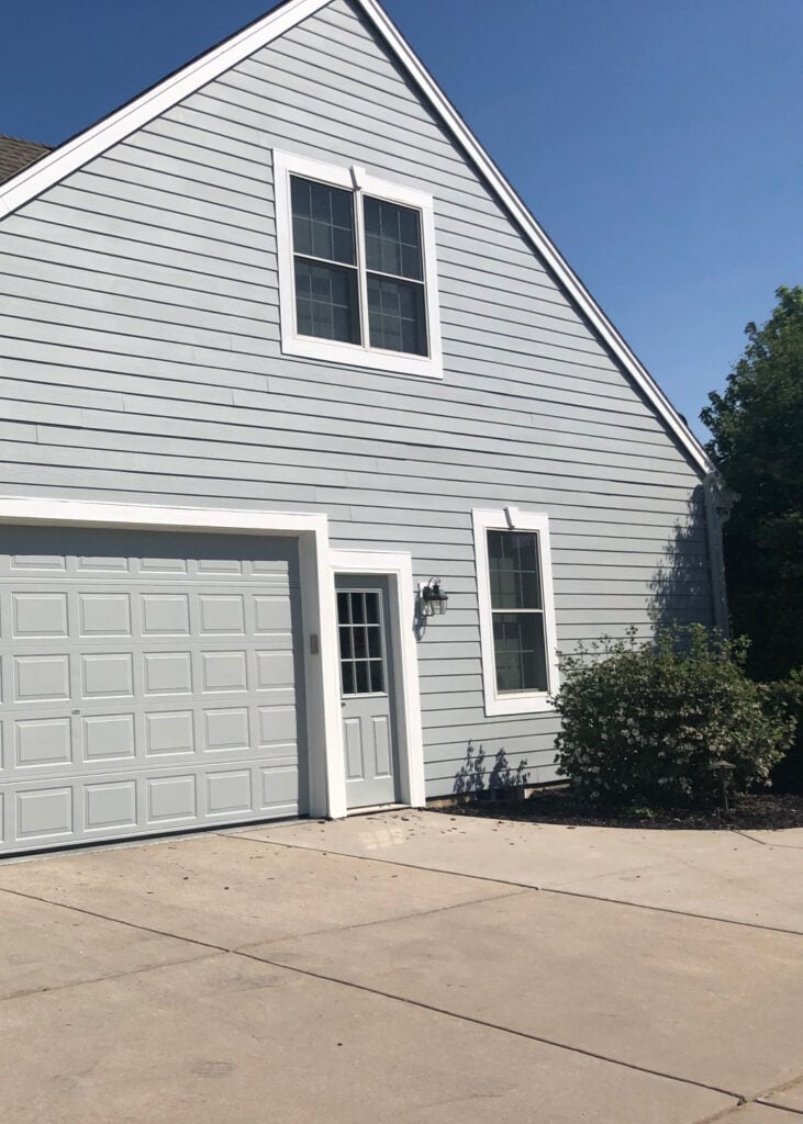 Sherwin Williams Mineral Deposit gray blue on exterior siding with white trim, GARAGE DOOR MATCHES THE SIDING