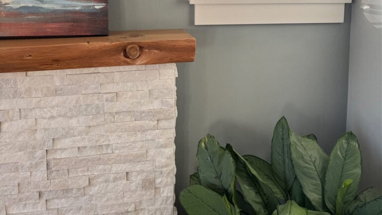 Benjamin MOore Puritan Gray walls with Cloud White trim, stone fireplace with natural wood mantel