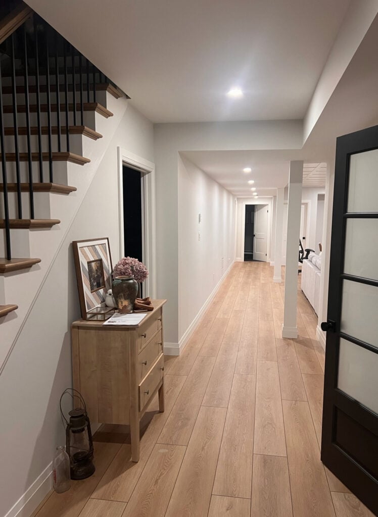 BEnjamin Moore Silver Satin dark, long basement hallway, laminate or LVP wood look floor, Pure White trim