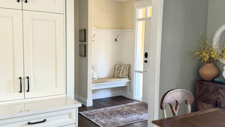Sherwin Williams Austere Gray kitchen, Antique White in entryway and Pure White cabinets and trim. Dark wood flooring in modern farmhouse home