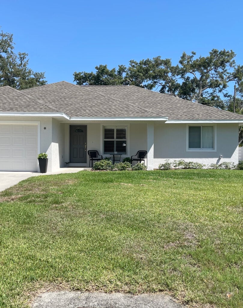 Sherwin Williams Egret White, Pure White, stucco exterior with warm gray taupe asphalt roof and white windows, single story ranch house