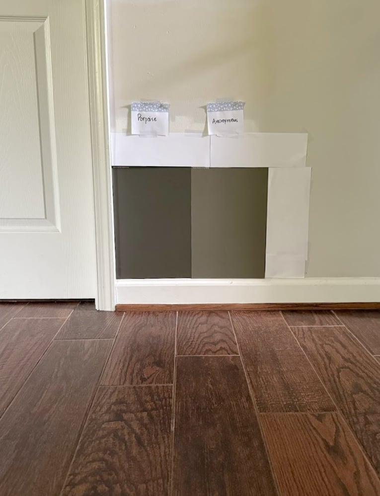 Sherwin Williams Porpoise vs. Anonymous with red stained wood floor (tile look) and white trim, dark greiges
