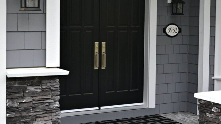 The best black paint colors, shown here Tricorn Black with gray siding and black stone