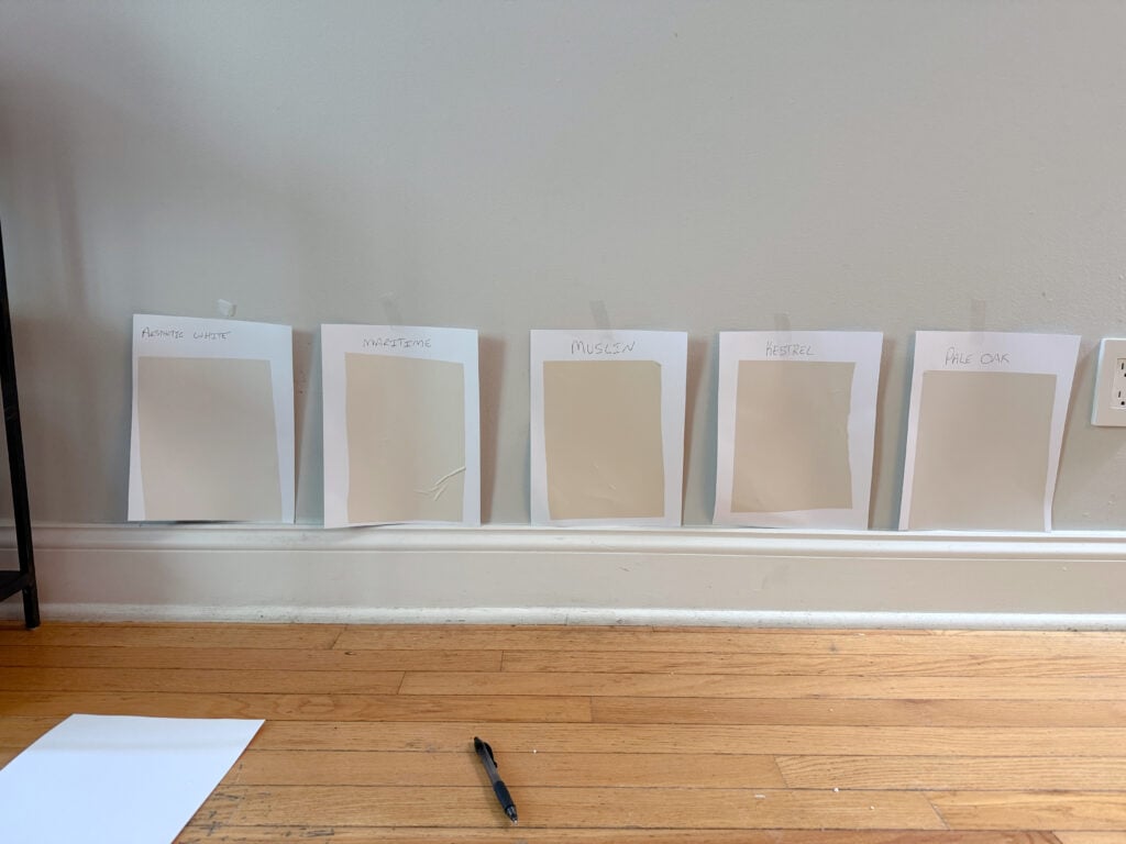 Samples of Sherwin Williams Aesthetic White, Kestrel White, Benjamin MOore Maritime White, Muslin, Pale Oak, beige and taupe samples with oak flooring - Copy