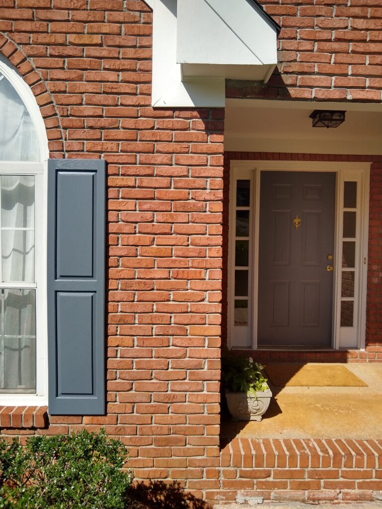 red orange brick exterior with blue shutters and Sherwin Williams Pure White trim