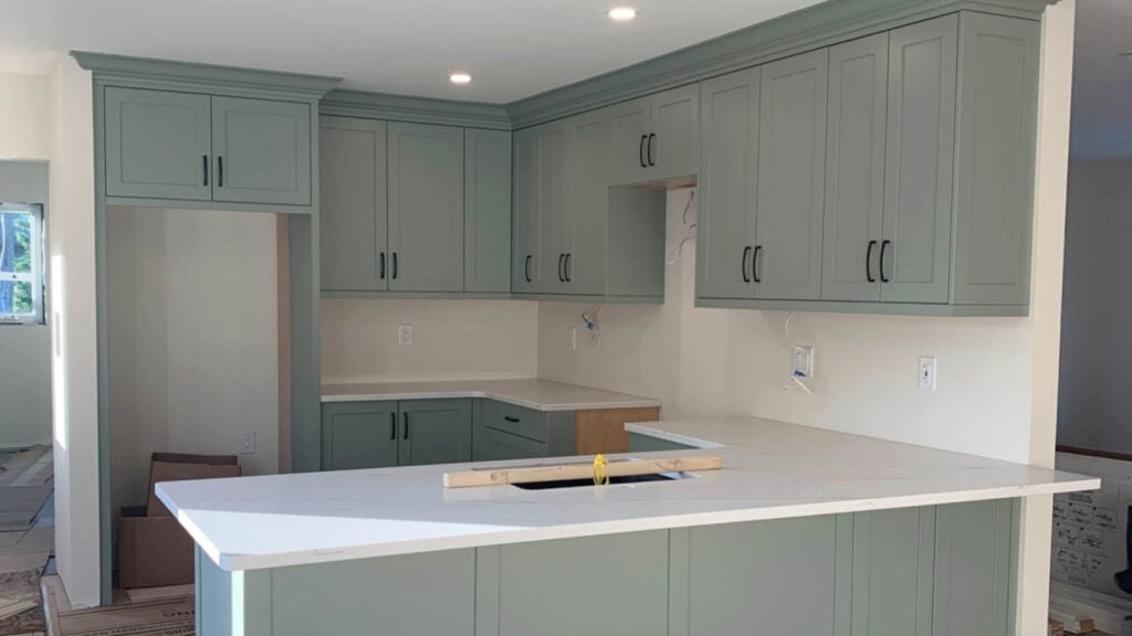 Sage green cabinet colors including Sherwin Williams Evergreen Fog with white quartz countertops