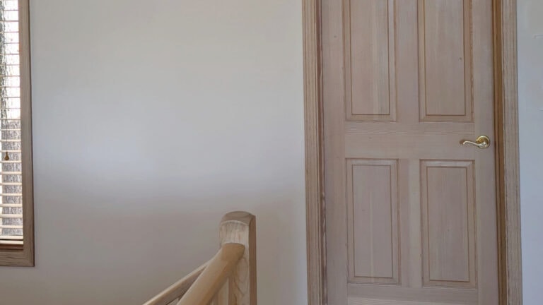 BEnjamin Moore Maritime White with wood trim and door, pink stain and subtle natural light