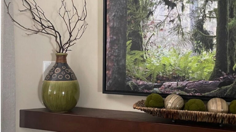 Benjamin Moore Manchester Tan with red stained wood mantel and green accents, east-facing exposure