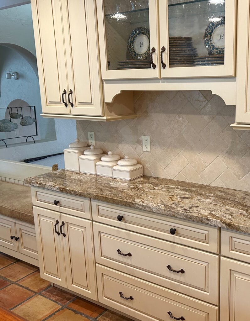 Cream glazed kitchen cabinets with warm beige gold granite countertop, saltillo tile floor, travertine tile backsplash update ideas (1)