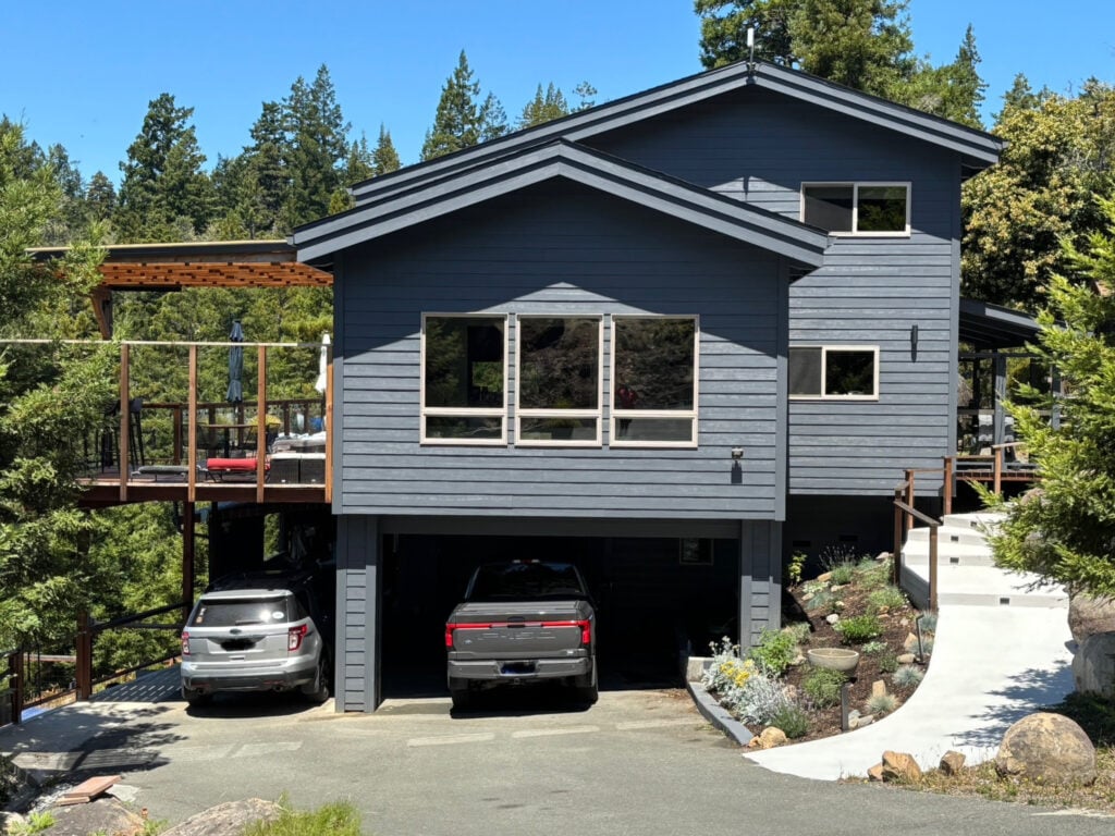 Exterior, West Coast style home, beige, tan, taupe windows, siding painted a dark blue paint color, Benjamin Moore Temptation, matching trim and fascia