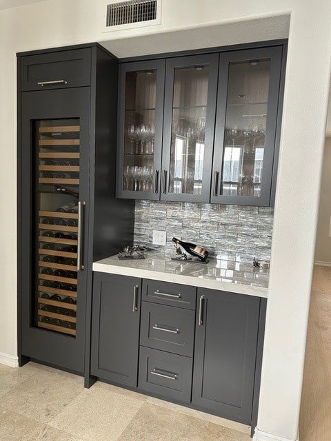 Home bar area painted Sherwin Williams Iron ore, travertine tile floor, quartzite countertop, River's Edge beige on walls