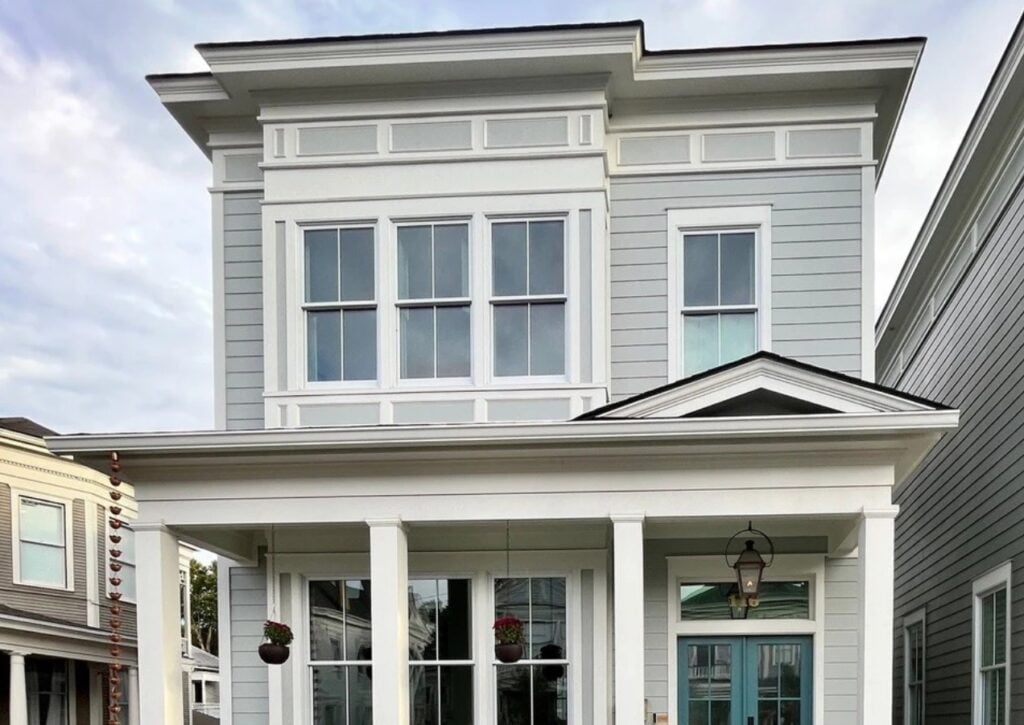 Bella Blue painted front door, Benjamin Moore Half Moon Crest gray-blue-green exterior siding, Pure White trim, flat roof, white gutters and windows - Copy