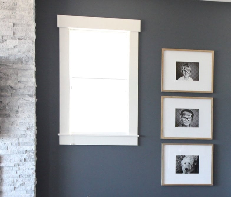 Benjamin Moore Anchor Gray, blue-gray with White Dove trim and framed photos