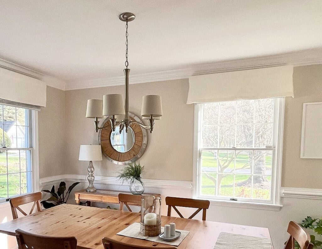 Benjamin Moore Chantilly Lace lower walls, trims, moldings, crown, and ceiling, White Sand upper walls - warm, neutral beige-tan, pine dining table