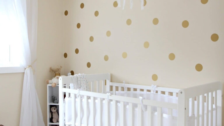Benjamin MOore Gentle Cream in baby nursery with white crib and gold dot decor