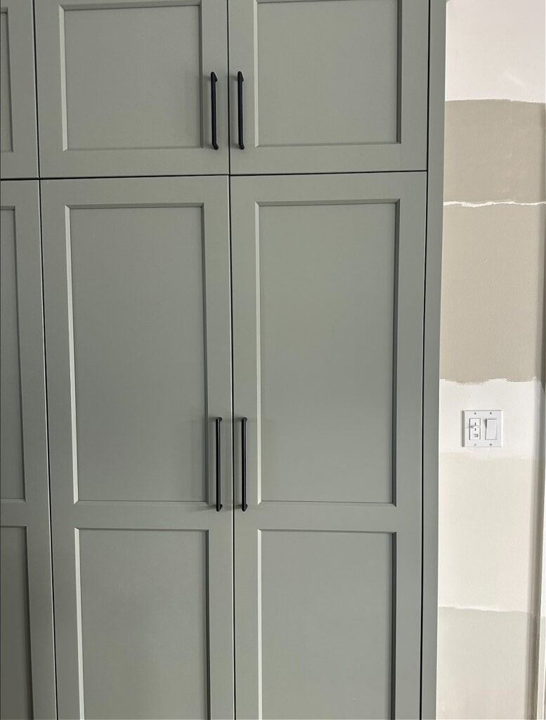 Benjamin Moore Storm Cloud Gray green-gray on kitchen cabinets, Sedate Gray sample on wall
