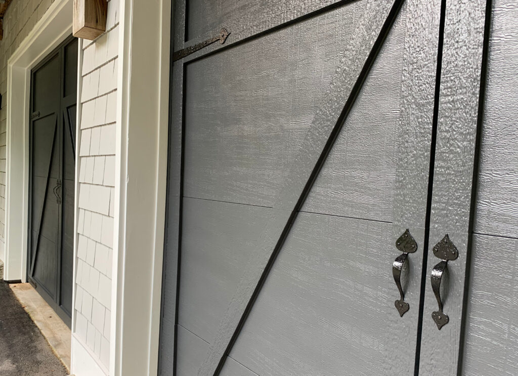 Closeup up Benjamin Moore Cheating Heart compared to black hardware on garage door